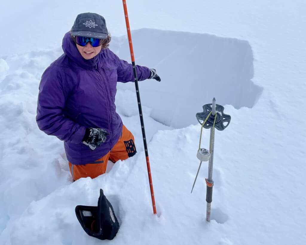 Madeleine demonstrating a snow profile during the ultimate everything course